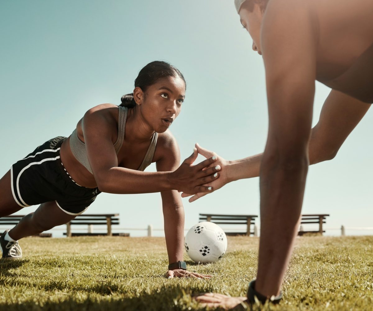Fitness partner, exercise and sport training with couple workout in a park doing pushup for wellnes